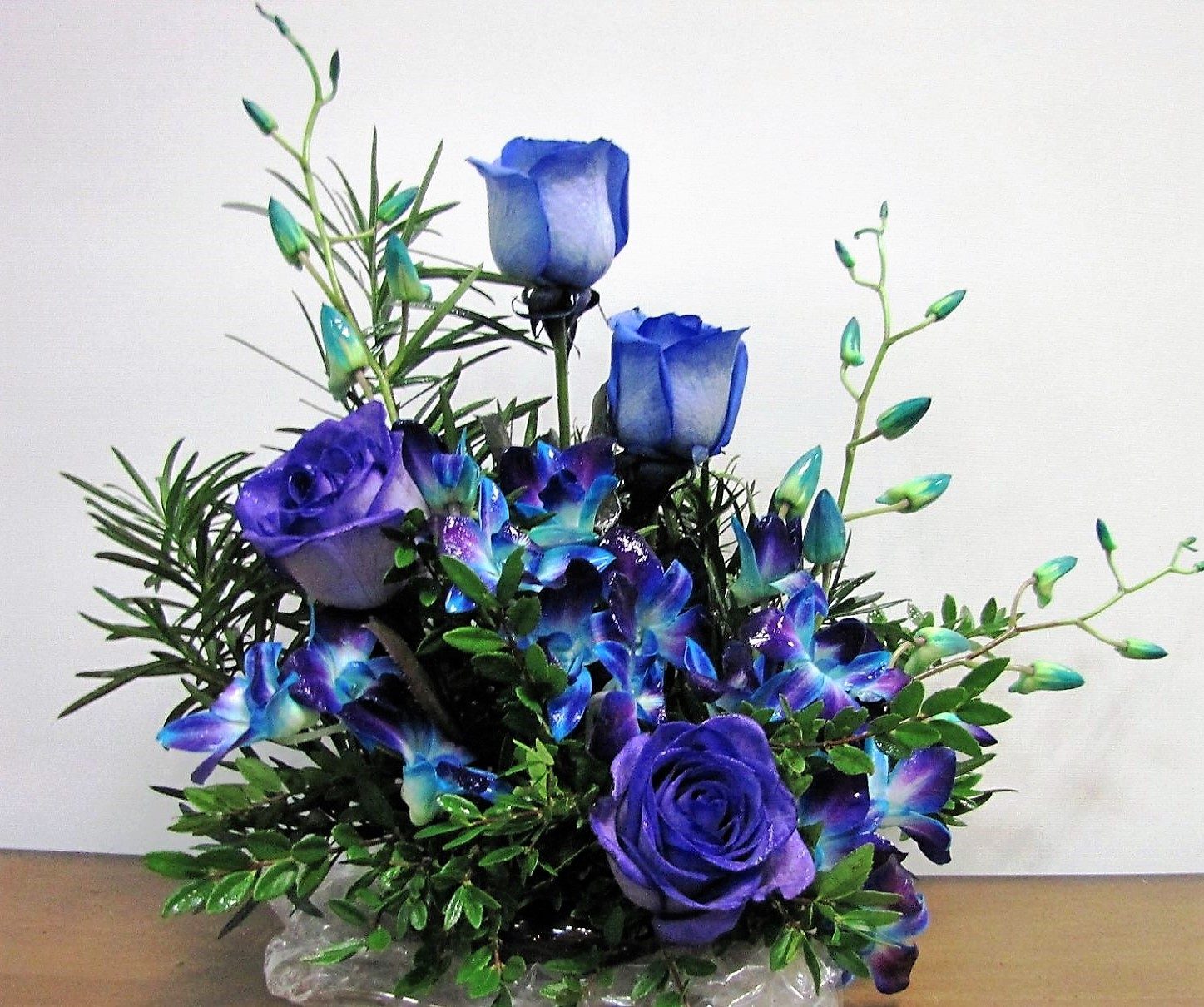 Blue orhids with blue roses and purple roses, a favourite floral arrangement